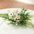 Complete wedding table setting with tall floral centerpiece