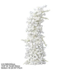 White curved floral arch paired with pillar candles for wedding styling