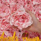 Artificial peony heads on wooden tray