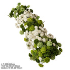 faux flower arch with white blooms and green spheres
