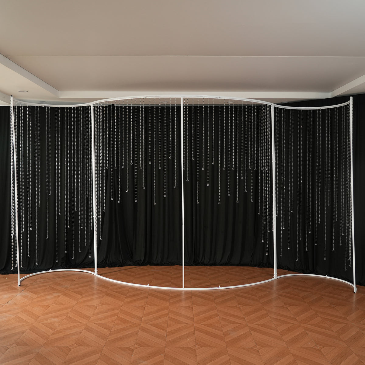 curtain backdrop paired with curved metal frame event background 