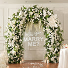 White spherical pompom flowers used on wedding arch decoration