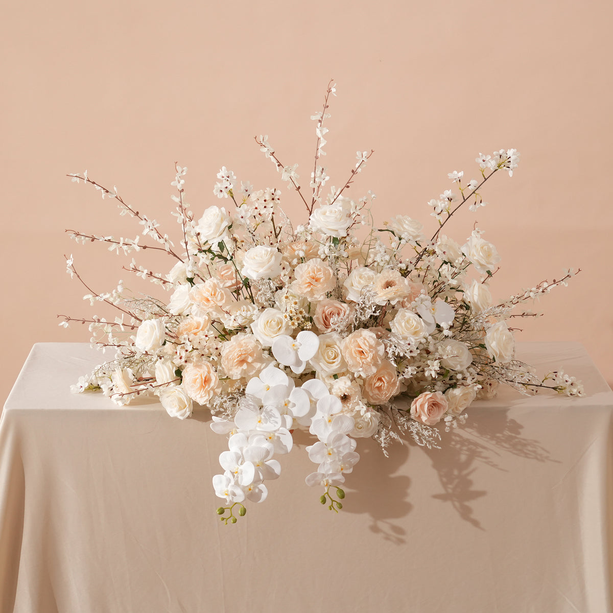 Wedding aisle decorated with champagne flower petals and candles