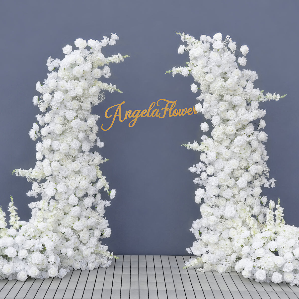 White curved floral arch decorated with lanterns and wedding signage