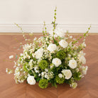 Soft textured white green mixed blooms wedding ground flower decor
