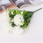 Faux pom pom flower with decorative green fern leaves