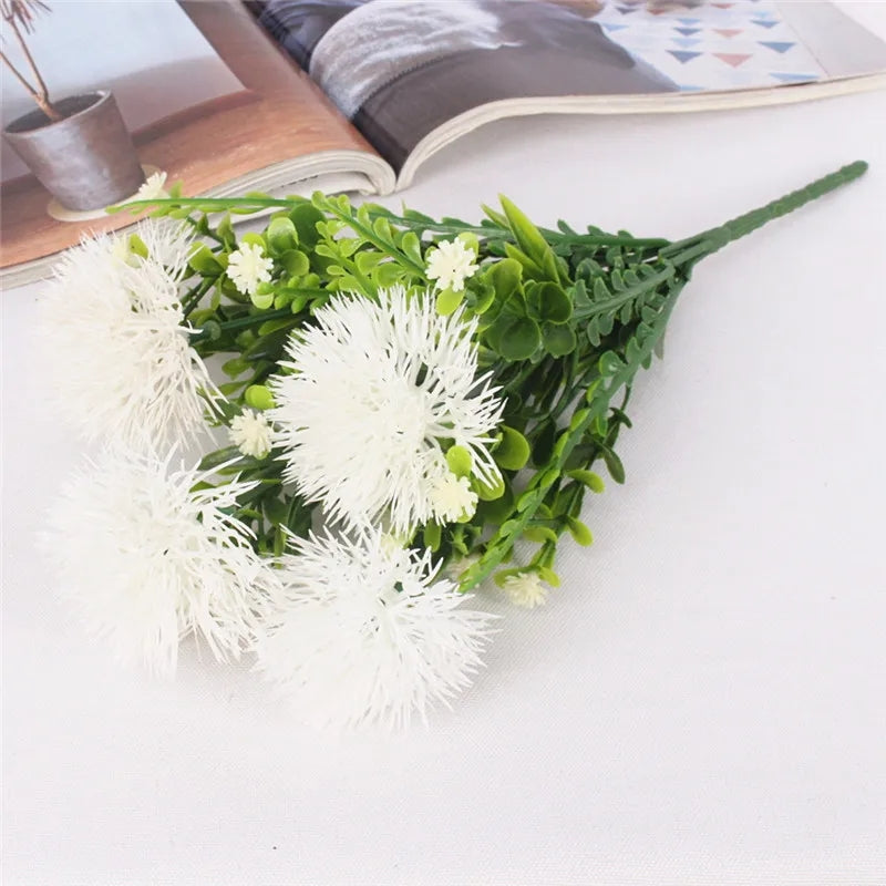 Faux pom pom flower with decorative green fern leaves